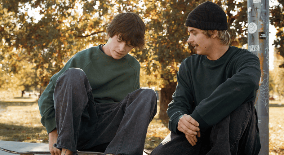 younger man and his father talking outside