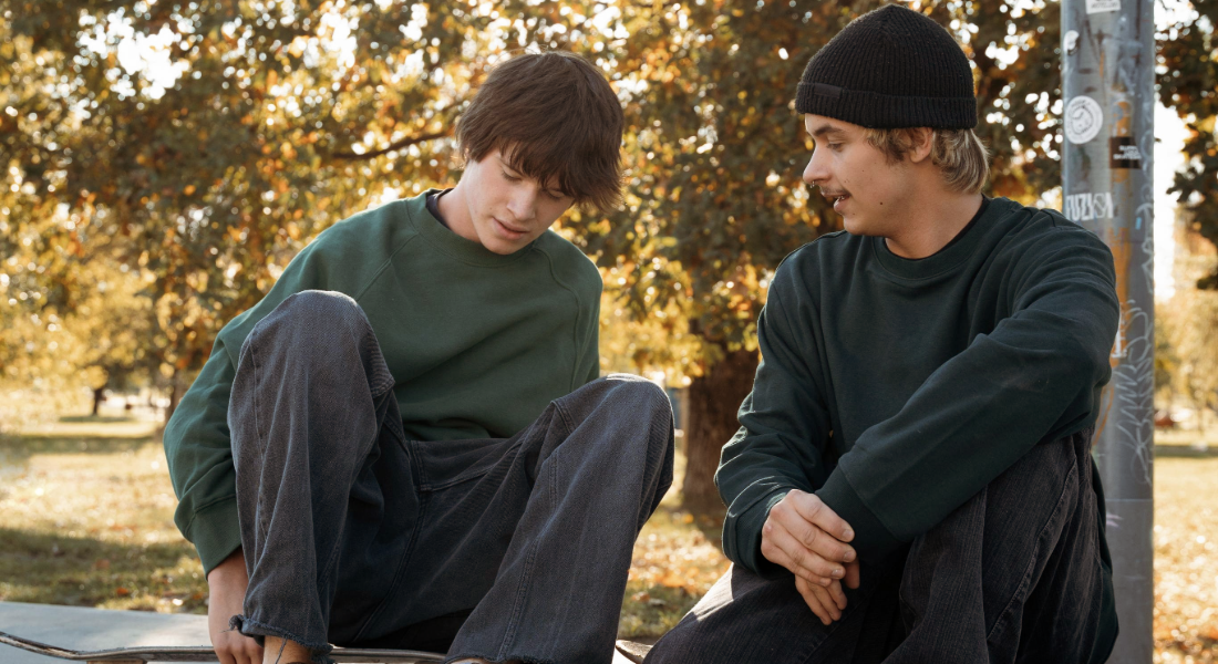 younger man and his father talking outside