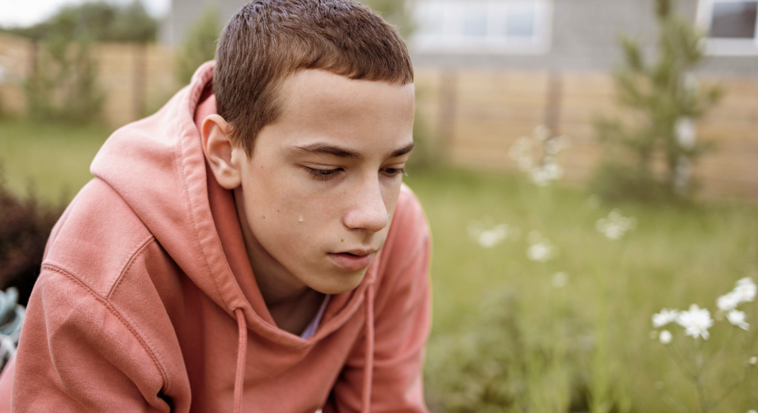 young man contemplating outdoors