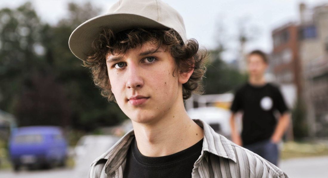 portrait photo of a young man in a hat